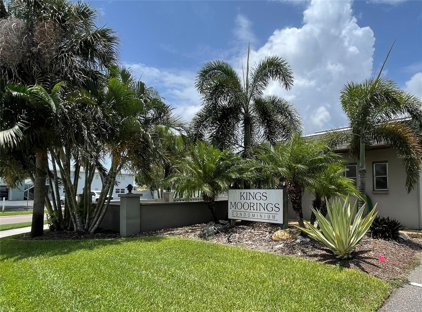 Overlooking the Broadwater subdivision this spacious 2/2 end unit condo at The King's Moorings is perfect for making your rounds at the Beaches, downtown St Pete, and Gulfport. The Pinellas County trail system runs through the Skyway District making it easy to get around with or without a car. Minutes from Eckerd College, restaurants, and shopping. The kitchen in this condo has been updated with modern appliances and stone counters. Other features include a coffered ceiling in the living/dining room. Primary bedroom is spacious with a full bath and closet is 8 ft wide with shelving on each side. Front bedroom has a walk in closet. Ample space for linens and such. Laundry Room and Storage Locker #211 are on the Second Floor near the elevator. The HVAC was replaced in 2020. SIRS completed, no assessments. Room sizes are approximate. Buyer to verify all data.