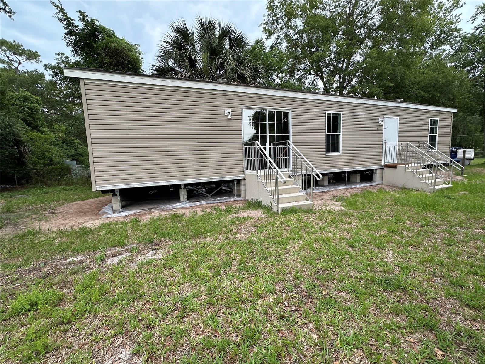 What a perfect spot for a quiet retreat in a golf cart friendly area. This 2019 built home has 2 bedrooms, 1 and a half bathrooms, and it includes kitchen appliances and washer and dryer. You can purchase this property with cash or VA financing. This property has access to the community boat ramp to the St. John's River for a yearly fee of $40. This property is not in a park, you own the land with no HOA or deed restrictions. Call today to take a look at this cute home!!