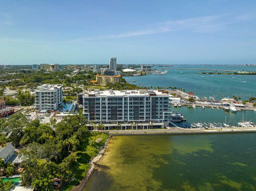 There's no place like home, especially in this 2 bedroom, 2 bathroom waterfront condo at the newly built Marina Bay 880 (Completed 2021) which gives unbeatable northernly open water views from this sixth floor luxury corner unit from the living room, dining room, kitchen areas as well as both bedrooms. As you enter the residence you immediately behold jaw dropping water views, an open concept design and features that only the best of the best will provide. High 9 foot ceilings, a farmhouse kitchen sink, quartz counter tops, large center island and loads of cabinets and over sized drawers for all your kitchen goodies and stainless steel GE Cafe appliances. The Primary Suite comes with two nice sized walk-in closets and a large, Primary Bath with double sinks and extra-large shower and it's own balcony. The second bedroom also has balcony access to the main balcony and there is a bonus den that could be used as an office or whatever your heart desires. There is a separate laundry room with additional storage and this unit comes with two parking spots! There is a 24 hour concierge at the front desk, a heated pool, putting green, Avant guard fitness center, steam room, sauna and so much more! The Homeowners association fees include water, trash, internet, cable, concierge, master insurance, amenities, and ground maintenance. Coming to Downtown Clearwater with restaurants and art stores and only a short distance to world famous Beach with its powdery, natural sands which draw visitors year round. Don't miss the opportunity to live in this fantastic building with all it has to offer, schedule a showing today!