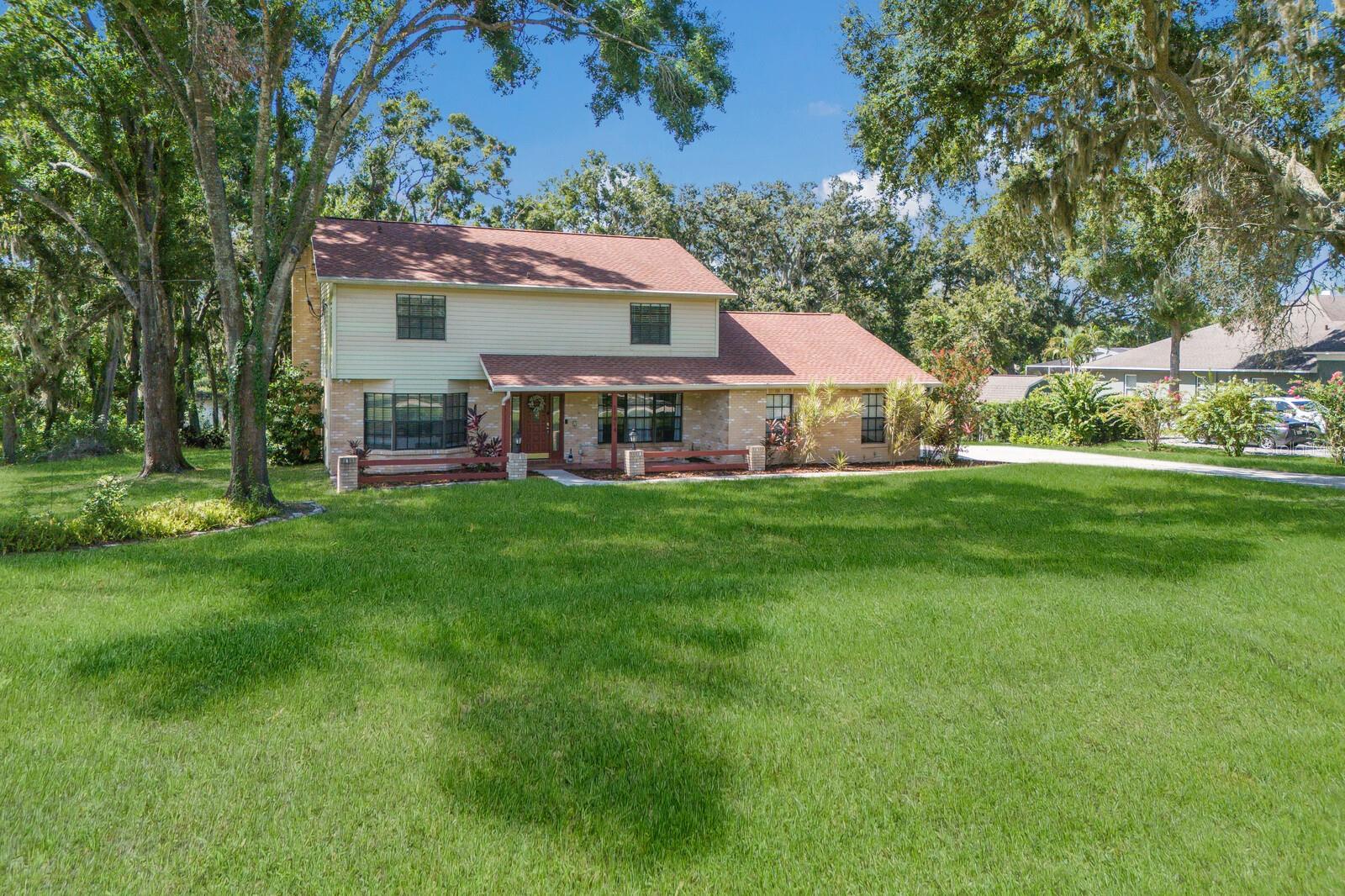Get ready to fall head over heels for this beautifully upgraded 4 bedroom home on a stunning one acre lakefront lot in highly sought-after Shadow Run. With panoramic views of Lake Grady & a peaceful country setting just minutes from city conveniences, this home delivers the best of both worlds. You will be wowed as you pull into the long driveway with a gorgeous elevated view of the huge lake in the backyard, welcoming you home. A cheery front porch invites you inside this flexible floorplan, featuring a formal dining room w/custom chandelier & a large flex room just off the entryway - ideal for a home office, playroom, media room, or home gym. Matte satin concrete floors on the 1st floor complement bold dark interior doors, creating modern striking contrast. A hallway leads you to the large gathering room & spacious kitchen, impressing with its finishes & thoughtful layout, including rich wood cabinets, stainless appliances, tile backsplash, single bowl sink, center prep island & granite counters. French doors off the kitchen open to the screened, covered lanai where you can enjoy stunning views of nature complete w/a huge dockable lake. Beyond the lake, a peaceful conservation area provides the perfect backdrop for total privacy & escape. Bring all your toys...the south-facing backyard offers plenty of room for outdoor enjoyment, relaxation, & fun in the sun, as well as cozy evenings with s'mores over the firepit. Solid surface flooring flows throughout the entire home, incl. NEW luxury vinyl planks in the bedrooms & 2nd floor hallways (late 2024), as well as a newly remodeled staircase (2024) showcasing stunning polished wood treads & crisp white risers. Upstairs, you’ll find 4 bedrooms including your large Primary Retreat, complete w/majestic double door entry, walk-in closet & en-suite bath w/dual granite vanities. 3 additional bedrooms are also upstairs, one w/a custom built-in closet, & all share a full bathroom w/granite counters. Back downstairs, you'll find the oversized laundry room/mudroom just off the kitchen, which includes washer, dryer, a walk-in shower, & backyard access - perfect for a future pool bath or even a pet washing station for your four-legged friends! A convenient half bath for guests is also on the 1st floor, tucked btwn the kitchen & gathering room. Additional upgrades & features include Ring security system, w/sensors on all exterior doors & windows; 4 exterior security cameras; video doorbell; dual HVAC units w/ NEW (2024) dual Google Nest smart thermostats; water softener; NEWLY painted front door (July 2025); NEW interior paint & wall texture throughout (2024/2025); NEW (2024/2025) modern 5 1/4" baseboards throughout; NEW (2024) ceiling fans throughout; NEW LED light fixtures throughout; & whole home gutters. And if all of that isn't fabulous enough, this home has NO CDD fees, LOW HOA fees, and even has a 5.99% Assumable FHA loan! Plus, with its own well and septic system, you can say goodbye to water bills for good! Located in highly desirable Shadow Run, this home offers a prime location just minutes from shopping, dining, & well-rated schools, as well as private access to the stunning 178-acre Lake Grady & scenic walking trails at the adjacent Bell Creek Nature Preserve. Enjoy quick & easy access to Boyette Rd, US-301, I-75, and the Crosstown Expressway, & just a 10 minute drive to the new AdventHealth Riverview Hospital, 15 minutes to St. Joseph’s South, and 35 minutes to MacDill Air Force Base.