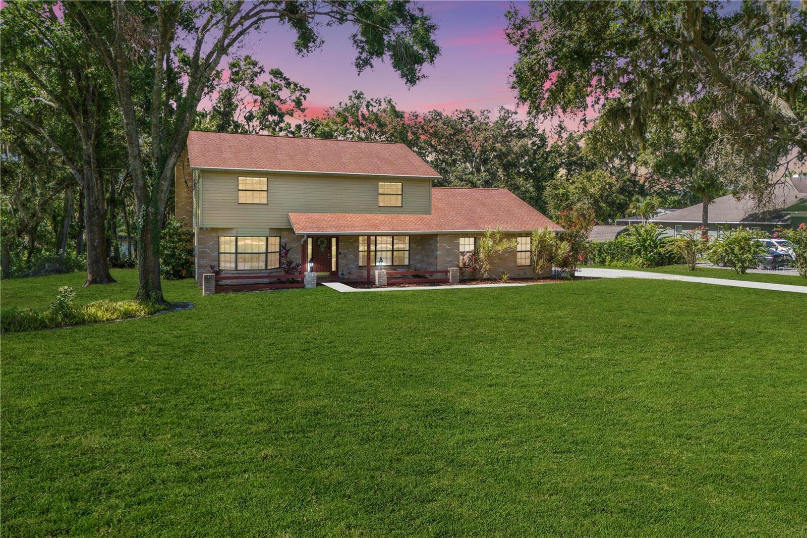 Get ready to fall head over heels for this beautifully upgraded 4 bedroom home on a stunning one acre lakefront lot in highly sought-after Shadow Run. With panoramic views of Lake Grady & a peaceful country setting just minutes from city conveniences, this home delivers the best of both worlds. You will be wowed as you pull into the long driveway with a gorgeous elevated view of the huge lake in the backyard, welcoming you home. A cheery front porch invites you inside this flexible floorplan, featuring a formal dining room w/custom chandelier & a large flex room just off the entryway - ideal for a home office, playroom, media room, or home gym. Matte satin concrete floors on the 1st floor complement bold dark interior doors, creating modern striking contrast. A hallway leads you to the large gathering room & spacious kitchen, impressing with its finishes & thoughtful layout, including rich wood cabinets, stainless appliances, tile backsplash, single bowl sink, center prep island & granite counters. French doors off the kitchen open to the screened, covered lanai where you can enjoy stunning views of nature complete w/a huge dockable lake. Beyond the lake, a peaceful conservation area provides the perfect backdrop for total privacy & escape. Bring all your toys...the south-facing backyard offers plenty of room for outdoor enjoyment, relaxation, & fun in the sun, as well as cozy evenings with s'mores over the firepit. Solid surface flooring flows throughout the entire home, incl. NEW luxury vinyl planks in the bedrooms & 2nd floor hallways (late 2024), and a newly remodeled staircase (2024) showcasing stunning polished wood treads & crisp white risers. Upstairs, you’ll find 4 bedrooms including your large Primary Retreat, complete w/majestic double door entry, walk-in closet & en-suite bath w/dual granite vanities. 3 addt'l bedrooms are also upstairs, one w/a custom built-in closet, & all share a full bathroom w/granite counters. Back downstairs, you'll find the oversized laundry room/mudroom just off the kitchen, which includes washer, dryer, a walk-in shower, & backyard access - perfect for a future pool bath or even a pet washing station for your four-legged friends! A convenient half bath for guests is also on the 1st floor, tucked between the kitchen & gathering room. Additional upgrades & features include Ring security system, w/sensors on all exterior doors & windows; 4 exterior security cameras; video doorbell; dual HVAC units w/ NEW (2024) dual Google Nest smart thermostats; water softener; NEWLY painted front door (July 2025); NEW interior paint & wall texture throughout (2024/2025); NEW (2024/2025) modern 5 1/4" baseboards throughout; NEW (2024) ceiling fans throughout; NEW LED light fixtures throughout; fireplace; & whole home gutters. And if all of that isn't fabulous enough, this home has NO CDD fees, LOW HOA fees, and even has a 5.99% Assumable FHA loan! Plus, with its own well and septic system, you can say goodbye to water bills for good! Located in highly desirable Shadow Run, this home offers a prime location just minutes from shopping, dining, & well-rated schools, as well as private access to the stunning 178-acre Lake Grady & scenic walking trails at the adjacent Bell Creek Nature Preserve. Enjoy quick & easy access to Boyette Rd, US-301, I-75, and the Crosstown Expressway, & just a 10 minute drive to the new AdventHealth Riverview Hospital, 15 minutes to St. Joseph’s South, and 35 minutes to MacDill Air Force Base.