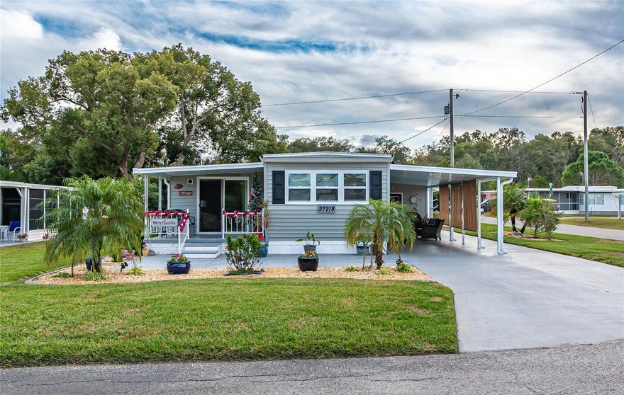 Come see this remarkable home in Betmar, a sought-after 55+ community where you own the land. This home will not disappoint! Situated on a corner lot with beautifully landscaped grounds and a new sprinkler system, you can relax on the welcoming front porch and enjoy the day.

The property features painted extra parking and a golf cart path leading to three backyard sheds—two with space for golf carts and a third housing the laundry area.

Step inside to find an updated kitchen with new appliances, a tiled backsplash, and a coffee bar with abundant storage. The kitchen opens to a bright and spacious dining area, perfect for entertaining. The primary bedroom and bath are located at the back of the home for added privacy.

The spacious living room and second bedroom are an added-on the left side with a concrete slab, providing extra living space. Additional updates include updated flooring and windows throughout, A/C (2020), and a membrane roof (2021) New electrical panel inside and outside.

Come and enjoy Betmar and all the amenities to including walking trails with bridges and ponds, two swimming pools, two hot tubs, tennis, pickleball, basketball, bocce, shuffleboard, mini golf, billiards, game rooms, a library, clubhouses, planned activities, Bingo, 27 holes of golf, and countless fun community events.