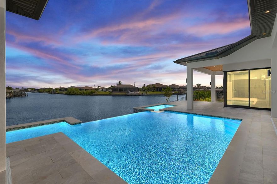 One or more photo(s) has been virtually staged. Experience exceptional craftsmanship and the ultimate Florida lifestyle in this brand new, custom-built home located in the fast-growing Northwest Cape Coral area. Constructed with energy-efficient ICF (Insulated Concrete Form) walls and topped with a sleek metal roof, this home is built to last while offering comfort, style, and safety. This spacious residence features 3 Bedrooms + Den, 3 Full Bathrooms, and a 3-Car Garage, encompassing 2,869 sq. ft. of luxurious living space. Step inside to soaring 14-foot ceilings, impact-resistant windows and doors, tile flooring throughout, and elegant architectural details throughout. The gourmet kitchen is a showstopper with Wolf/SubZero appliances, Quartzite kitchen countertops, a hidden walk-in pantry, and custom built-in features. Retreat to your primary suite, where you’ll find custom built-in closet cabinets designed for both beauty and functionality. 

Step outside to your private paradise — an infinity-edge heated pool and spa, expansive covered outdoor kitchen area, and a separate grill station, all overlooking a stunning 230-foot-wide intersecting gulf access canal. Enjoy tranquil northern exposure and spectacular water views, perfect for evening relaxation or entertaining guests. Additional highlights include a whole-house reverse osmosis system, smart-home features, and refined finishes throughout. This is more than a home — it’s a statement of modern waterfront luxury. Don’t miss your chance to own a piece of Cape Coral’s most exciting and fast-growing neighborhood. Schedule a tour today and see it for yourself!