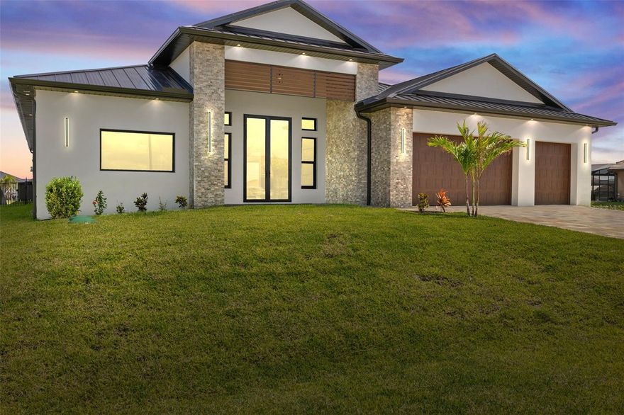 One or more photo(s) has been virtually staged. Experience exceptional craftsmanship and the ultimate Florida lifestyle in this brand new, custom-built home located in the fast-growing Northwest Cape Coral area. Constructed with energy-efficient ICF (Insulated Concrete Form) walls and topped with a sleek metal roof, this home is built to last while offering comfort, style, and safety. This spacious residence features 3 Bedrooms + Den, 3 Full Bathrooms, and a 3-Car Garage, encompassing 2,869 sq. ft. of luxurious living space. Step inside to soaring 14-foot ceilings, impact-resistant windows and doors, tile flooring throughout, and elegant architectural details throughout. The gourmet kitchen is a showstopper with Wolf/SubZero appliances, Quartzite kitchen countertops, a hidden walk-in pantry, and custom built-in features. Retreat to your primary suite, where you’ll find custom built-in closet cabinets designed for both beauty and functionality. 
Step outside to your private paradise — an infinity-edge heated pool and spa, expansive covered outdoor kitchen area, and a separate grill station, all overlooking a stunning 230-foot-wide intersecting gulf access canal. Enjoy tranquil northern exposure and spectacular water views, perfect for evening relaxation or entertaining guests. Additional highlights include a whole-house reverse osmosis system, smart-home features, and refined finishes throughout. This is more than a home — it’s a statement of modern waterfront luxury. Don’t miss your chance to own a piece of Cape Coral’s most exciting and fast-growing neighborhood. Schedule a tour today and see it for yourself!