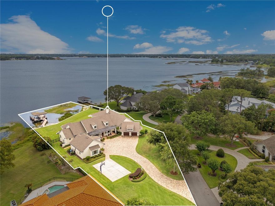 Over 150 feet on Lake Down provides panoramic views of what is arguably the cleanest of the Pristine Butler Chain of Lakes with a white sand beach and crystal clear water it will be like having your own resort in the backyard..Bayshore Drive is a rare and exclusive peninsula with grand oaks lining the paved road providing that “Old Florida” feel - plenty of shade for the perfect place to exercise and enjoy a walk or bike ride..Positioned on the North side of Windermere traffic is light making it easy to get to the Turnpike, 408 or the 429 saving you precious time for trips to the Airport or commutes into Downtown Orlando..This 2013 Parade of Homes Favorite “The Nantucket” is the perfect floorplan for anyone looking for a 1 story open floorplan having 4 full Suites-Separate Office with paneled walls and built in cabinetry, expansive Kitchen, Massive Pantry and Dining Room with 2 separate interior entertaining areas and a huge exterior covered screened porch overlooking the lake and pool that includes a TV, fireplace and BBQ system that will make the Grill Master smile..The home is designed to allow natural light to pour in without the direct heat from the sun..The Primary Suite truly feels like a resort spa with a soaking tub having a corner view of the lake, 2 large walk in closets, Spacious Shower with multiple heads, 2 Vanities with custom designed mirrors, the Bedroom has a nearly 180 degree unobstructed view of the lake with the most dramatic sunrises that will inspire and stir your soul..The attention to detail from the Reclaimed Brick on the front porch, Stacked Stone on the paneled columns, Herringbone Hand Scraped Oak Entry flooring, Tongue & Groove Ceilings, Tray Ceilings and Crown Moulding, 24 ft wide & 10 ft tall Pocket Glass Doors & 10 ft tall Corner Glass Sliding Pocket Doors open to the nearly 1,200 Sq Ft Covered Porch, Hand Hewn Beams in Family & Game Rooms, The Expert Carpentry Craftsman that installed the wall paneling and created the custom built shelving for closets and entertainment centers, Niches properly placed throughout to maximize the storage and open hallways, The timeless Kitchen is designed for the Gourmet Chef that likes to entertain having a large island with prep sink and plenty of seating for friends, Farmhouse Sink overlooking the lake, Stainless Wolf 6 Burner Natural Gas Cooktop with a custom Range Hood, Stainless Wolf Double Oven & Microwave, Stainless Sub-Zero Freezer/Fridge that backs up to the Massive Pantry and a 2nd Office, large Laundry area and Mudroom that has direct access to the Garage, Retractable Porch Screens with the tracks hidden inside the columns & ceiling, Even the Boathouse has upgraded Decking, Paneled Columns, Tongue & Groove Ceiling with Crown Moulding & Recessed Lighting..The backyard is large enough to have a football or soccer game with the kids or get competitive in the front yard on the Basketball or Pickle Ball Court..The positioning of the home offers incredible privacy without any of the Neighbors homes having a view of the pool area or Summer Kitchen..The “Car Guy” will love 4 separate garages with plenty of room for 4 Cars/Trucks & additional space for a workshop..The Town of Windermere is a charming and quaint community offering seasonal events & Food Trucks, Friday Farmer’s Markets, and soon to have an Italian Restaurant, Wine Club and Ice Cream Parlor joining the existing Café and Brewery making the “downtown” even more inviting..Must See this unique home