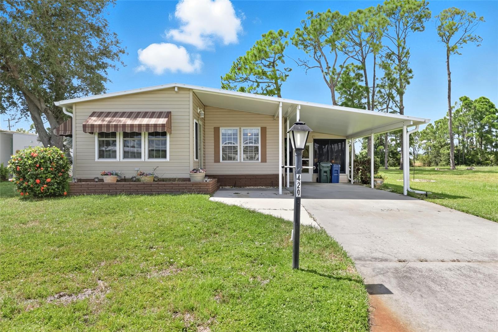 New to the Market and Ready to Rent for Season. This lovely 2-bedroom, 2-bath manufactured home is beautifully furnished. Step inside the inviting lanai and discover a large, air-conditioned room with carpeting and breathtaking views perfect as an entertaining space for family and friends.  The home offers an updated kitchen with newer appliances and opens to the dining room/living room combination that is spacious yet cozy. There is a Florida Room on the front of the house, which is also carpeted and under air, and is a second TV room when one is not enough. The primary bedroom with an en suite bath boasts a walk-in closet and a walk-in shower. The guest room has a full-size Murphy bed and a walk-in closet. The guest bath across the hall is generous in size with a shower/tub combo.  Outside the back of the home, there is a paver patio that extends the length of the home for those comfortable evenings when you want to enjoy the outdoors.