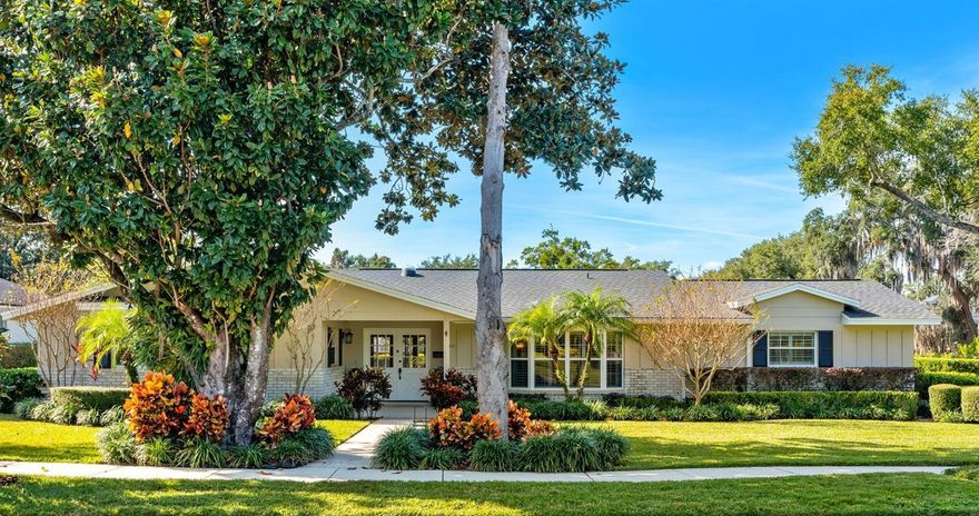 Welcome to 1421 Sunnyside Drive in Maitland, a beautifully maintained home where timeless design meets modern luxury. This 4-bedroom, 2.5-bath corner lot residence with a pool has a thoughtfully designed indoor and outdoor living space. Its location provides quick access to top-rated schools, boutique shopping, and local dining in one of the most desirable neighborhoods in the Maitland and Winter Park area. From the moment you arrive, the manicured landscaping and inviting covered front porch set the tone. Inside, natural light fills the home through skylights and bay windows, highlighting gleaming hardwood floors and a stunning wood-burning fireplace. The open layout connects each living space seamlessly, creating an ideal flow for everyday living and entertaining. The chef’s kitchen serves as the heart of the home, complete with custom hardwood cabinetry, granite countertops, stainless steel appliances, a wine chiller, and a spacious breakfast island with ample seating. Every detail balances style and function, making this kitchen a standout feature. The primary suite offers a peaceful retreat with wood floors and French doors leading directly to the porch. The ensuite bathroom features an oversized shower with spa-style jets and customized storage. Down the hallway—finished in classic terrazzo—are three additional bedrooms and a full bath with custom upgrades. The dining area captures beautiful morning light through the bay window, while a cozy living room with French doors opens to the outdoor living space. The private backyard oasis is designed for year-round enjoyment, featuring a heated pool enclosed by a full screened deck and patio area. Start your day with a sunrise on the front porch and end it with sunset views by the pool, giving the home a seamless indoor-outdoor feel that you will love. Additional highlights include a custom built-in home office with abundant storage, a freshly refinished two-car garage, and an oversized driveway equipped with a 30-amp electrical hookup for an RV or boat. The home has been freshly painted inside and out, includes new carpet, and reflects quality craftsmanship throughout. This move-in-ready Maitland home seamlessly combines original charm with modern upgrades—making it an exceptional opportunity for anyone looking for a well-maintained, thoughtfully designed property in a prime Central Florida location.