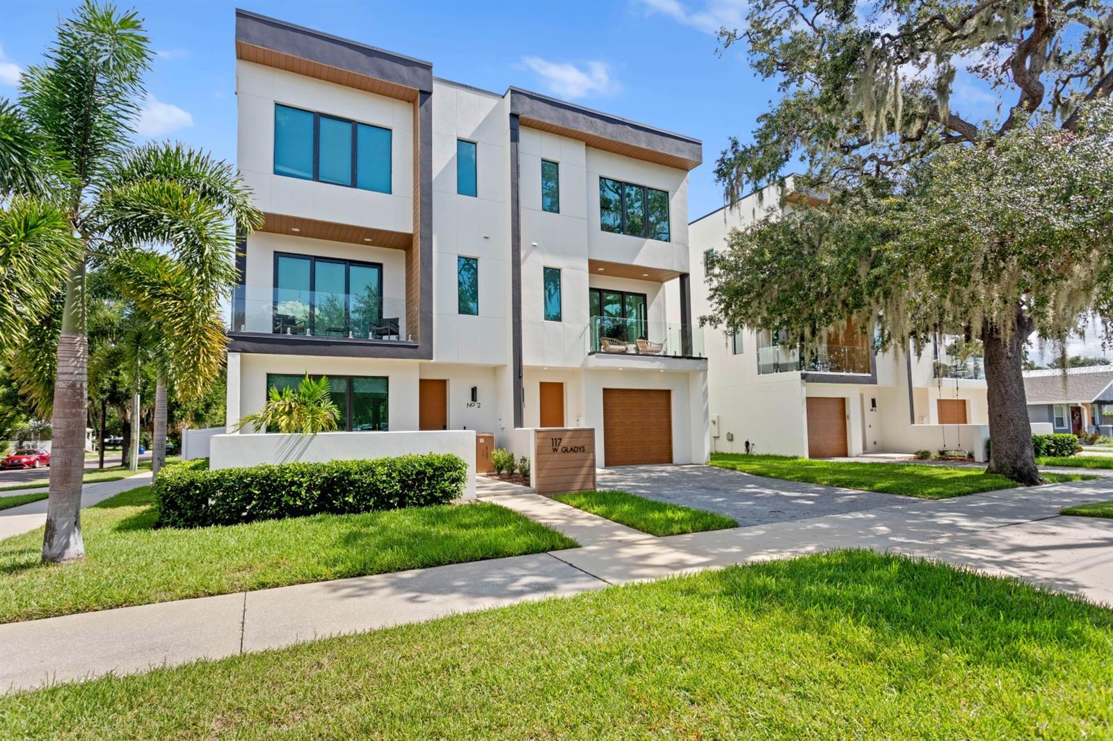 Welcome to convenient living in the heart of vibrant Tampa Heights! No HOA, block-constructed townhome with hurricane impact windows, a private backyard, second-floor balcony and sleek, modern finishes. Walkable to Armature Works, the Tampa Riverwalk, and so many awesome restaurants, bars, and coffee shops. Spanning 3 stories and 2,125 SF, this townhome offers 3 spacious bedrooms, each with its own en-suite bath, plus a designer powder room on the main living level. The second floor features an open-concept living area with a show-stopping floor-to-ceiling glass wall, a chef's kitchen with quartz countertops and stainless steel appliances, and a private balcony. The third-floor primary suite includes a large walk-in closet and a spa-inspired bath. Additional features include all-block construction, a 1-car garage, a fenced backyard, and abundant natural light throughout. Close proximity to the University of Tampa & only about a 10-minute drive to Tampa International Airport.