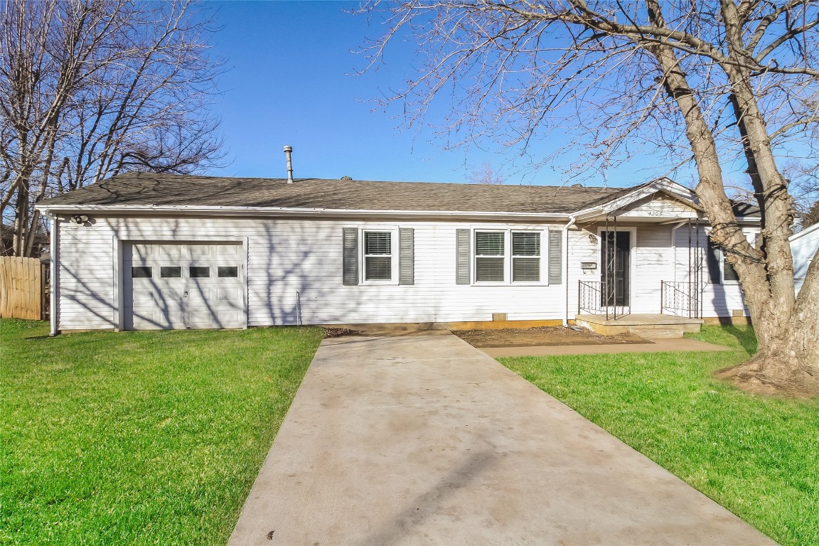 Ranch-style house with a garage, concrete driveway