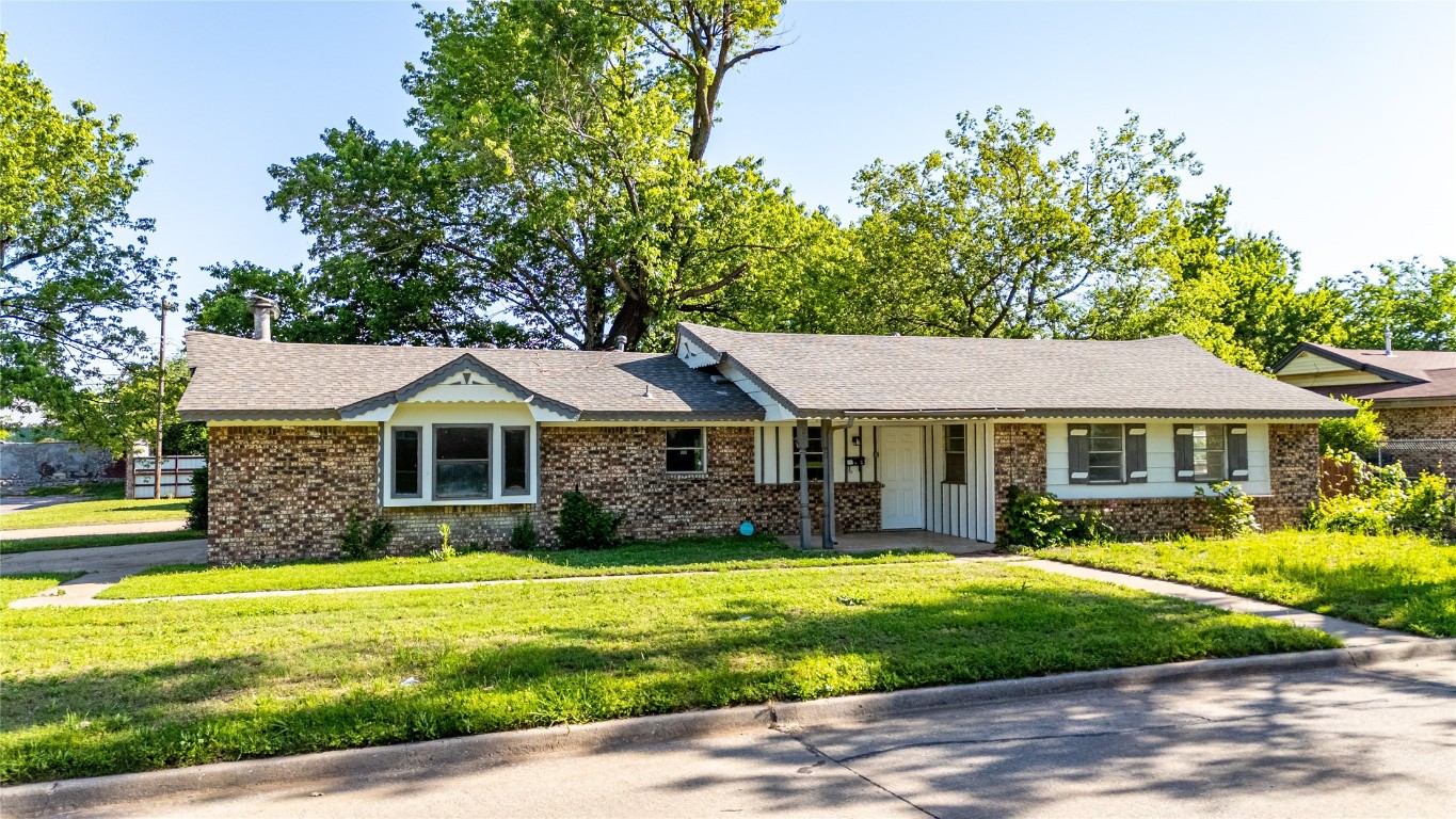 Single story home featuring brick siding, a front