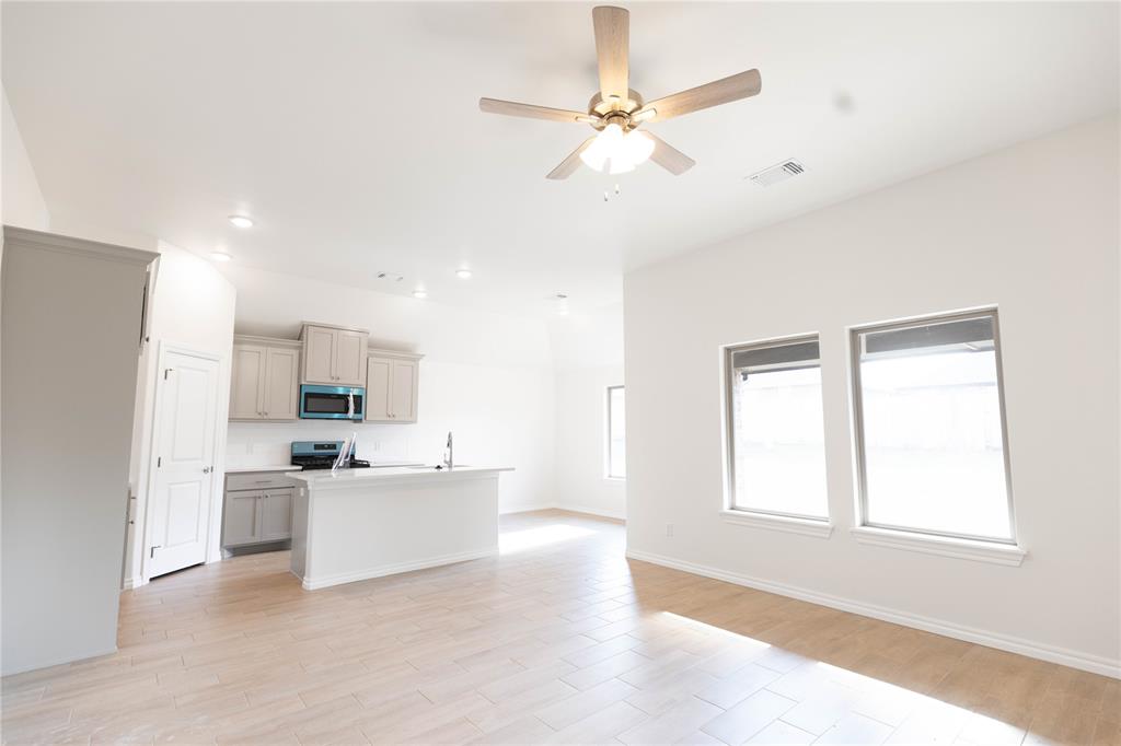 The property features exposed wood framing and ceiling rafters, showcasing the construction phase