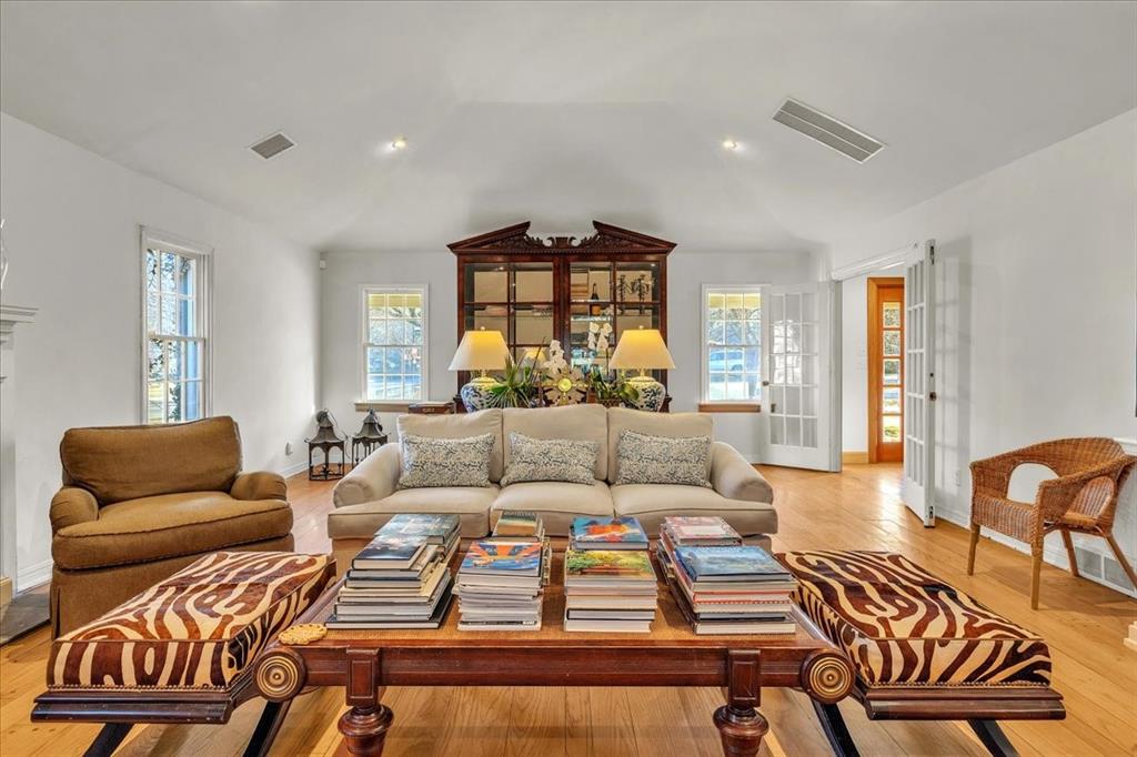 Living area with wood finished floors, lofted ceiling, and recessed lighting