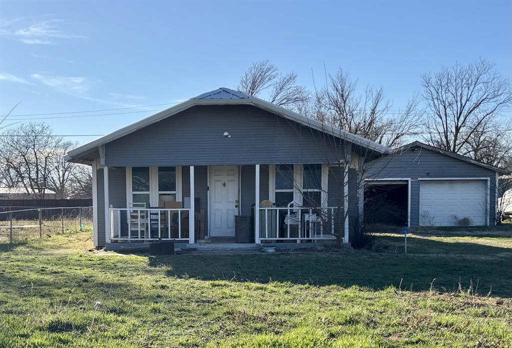 View of front of home featuring a porch and a garage