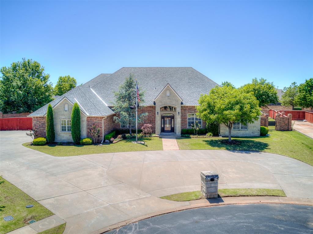 Expansive brick and stone exterior with a large circular driveway