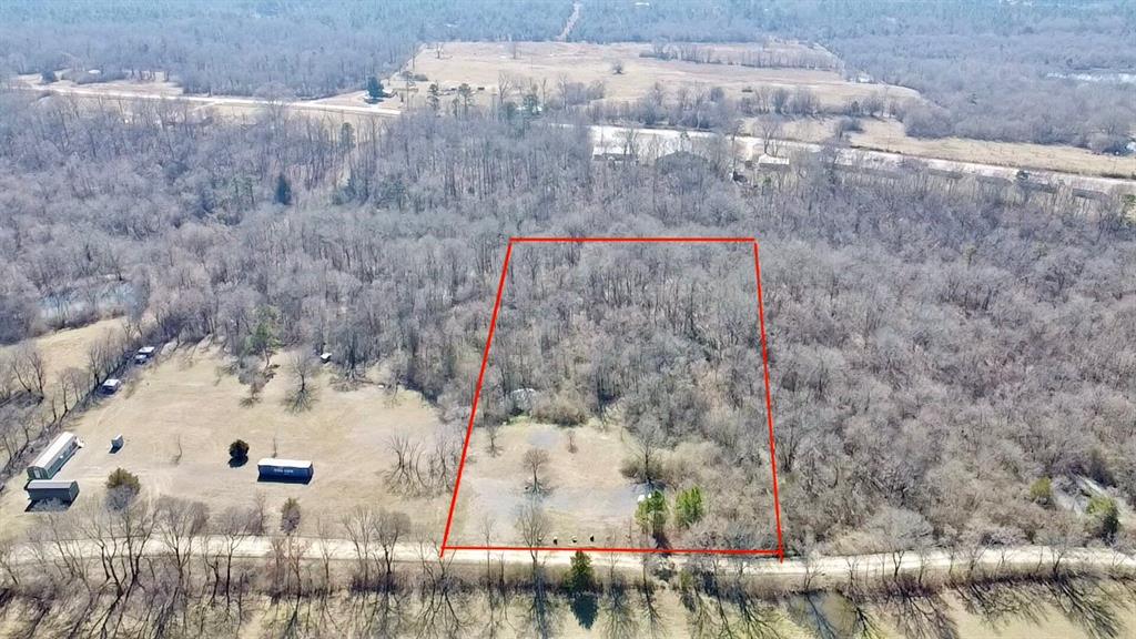View of property location featuring a heavily wooded area and property parcel outlined