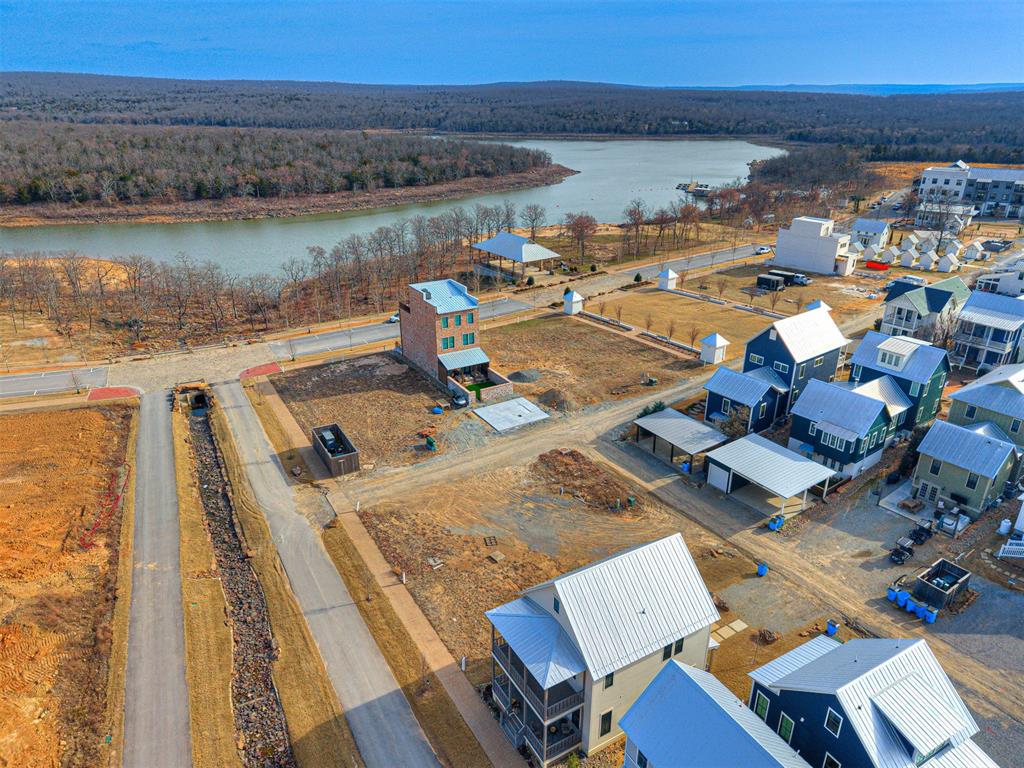 Drone / aerial view of a nearby body of water and a forest