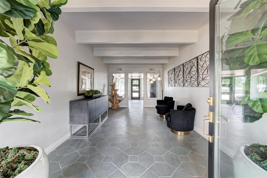 Entrance foyer with beamed ceiling and baseboards