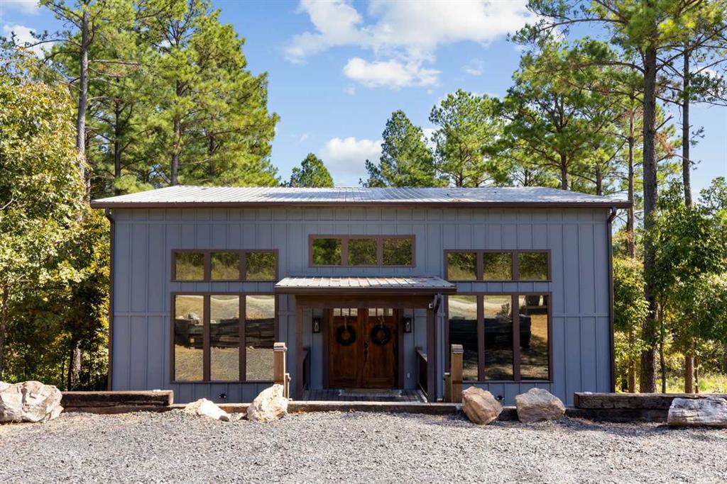 View of outbuilding with view of wooded area