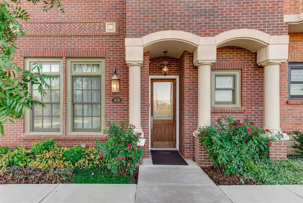 Brick facade with stone accents and a covered entryway