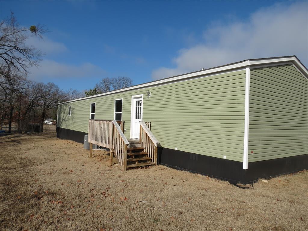 Back of property featuring a yard