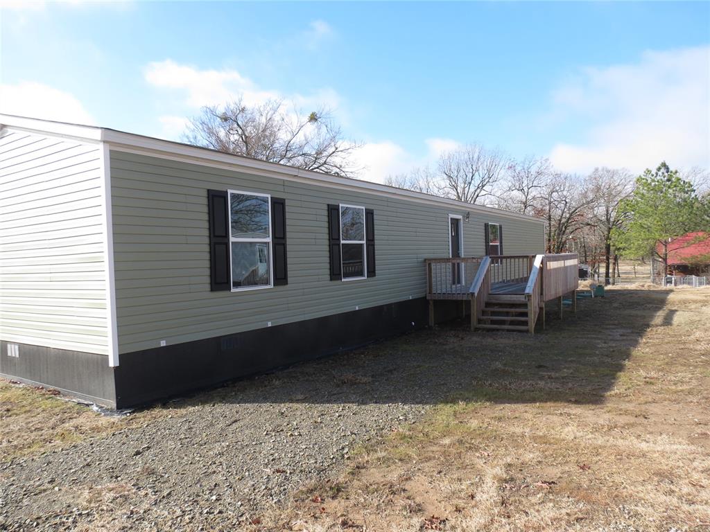 Rear view of property featuring a wooden deck