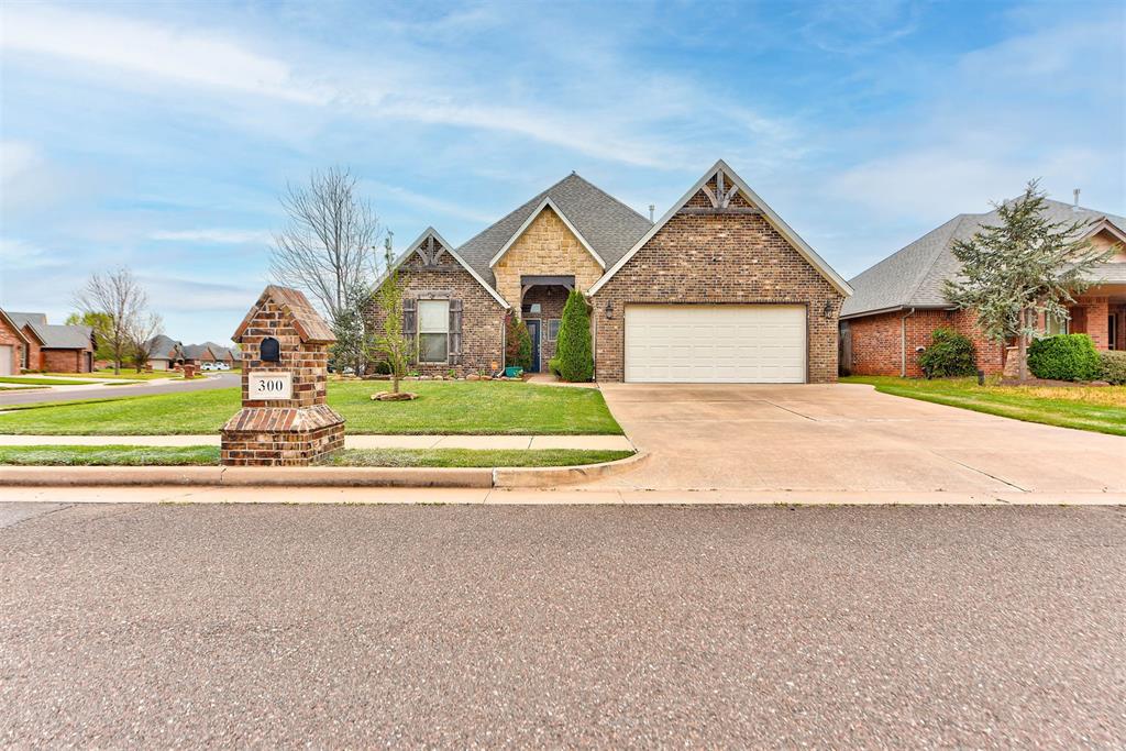 Craftsman-style home featuring a shingled roof, a front lawn, brick siding, concrete driveway, and an attached garage