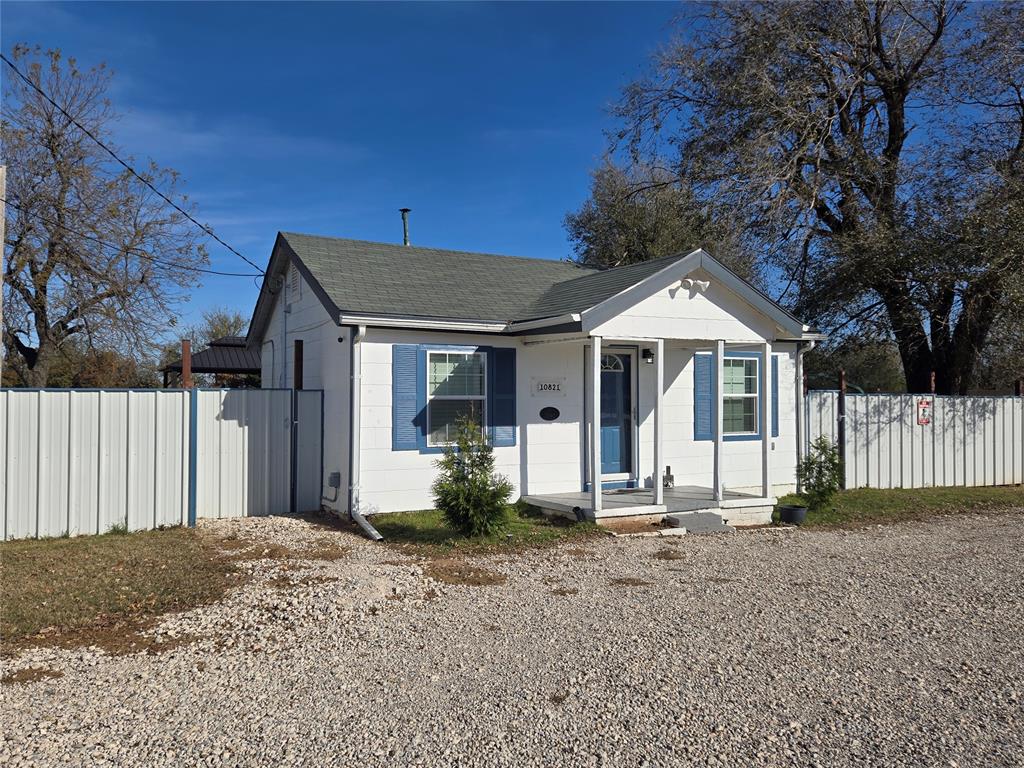 Bungalow with a shingled roof and concrete block siding