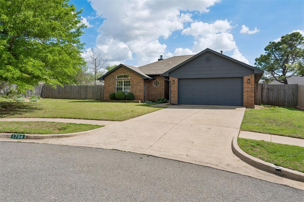 Brick exterior with a dark gray garage and complementary siding