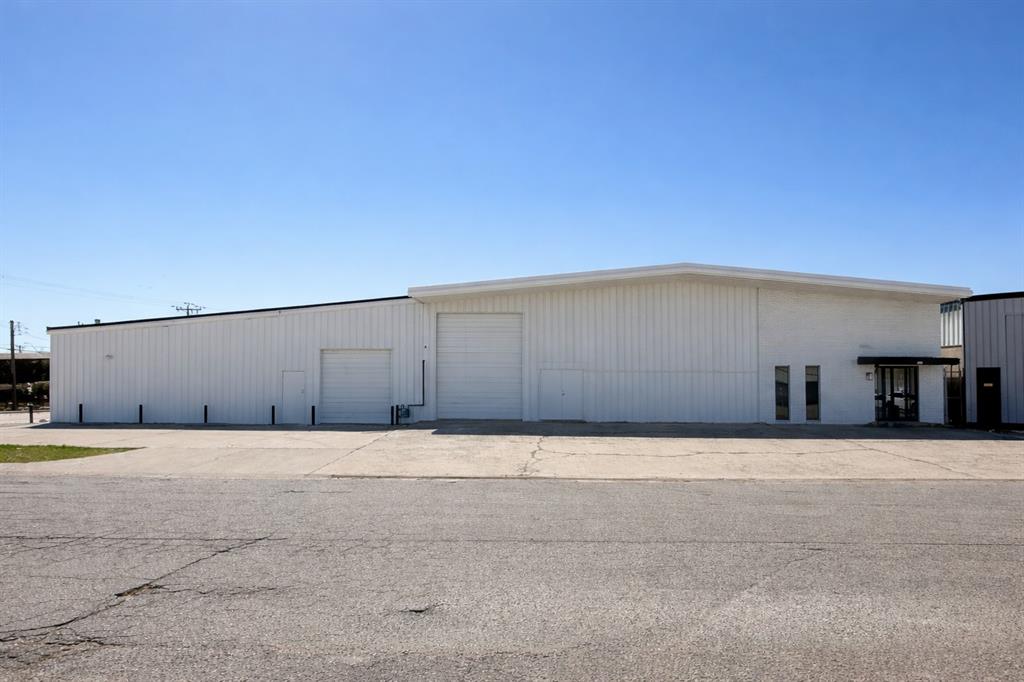 View of property with a detached garage