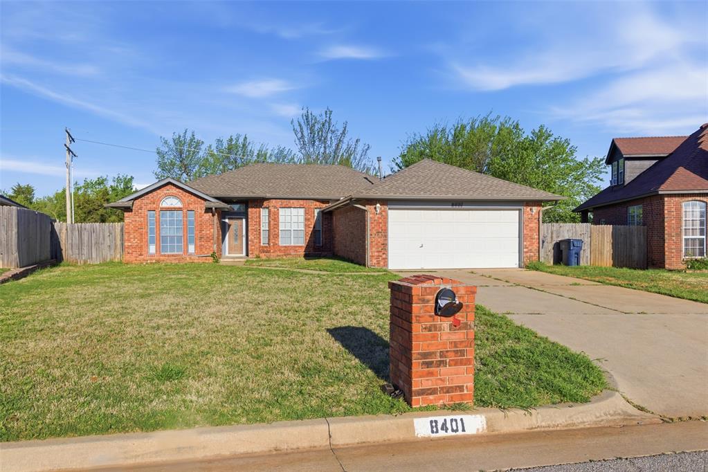 Ranch-style house with brick siding, an attached garage, concrete driveway, and roof with shingles