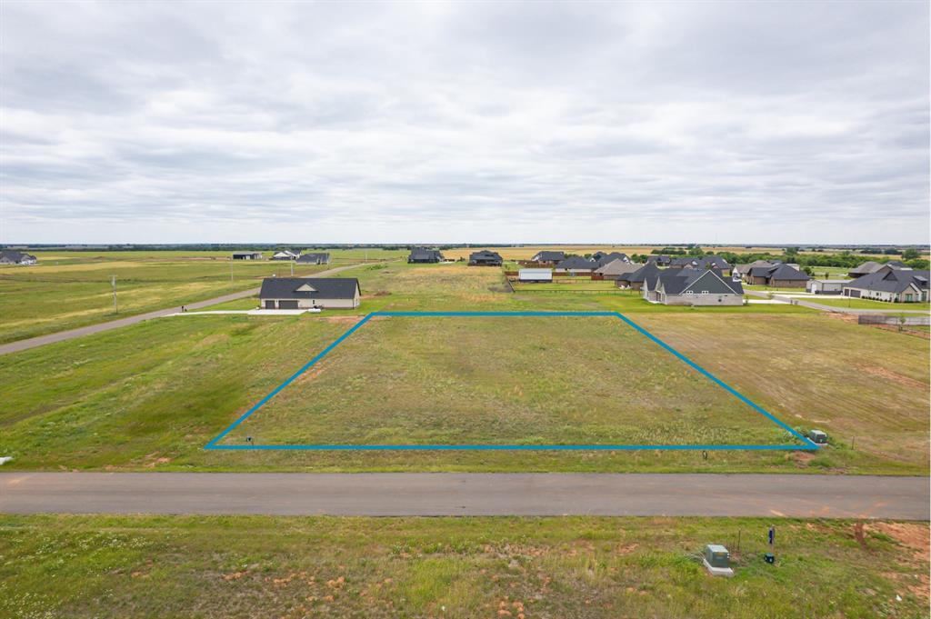 Expansive residential lot featuring undeveloped terrain and roadside access