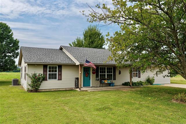 Single story home featuring a front lawn and roof with shingles