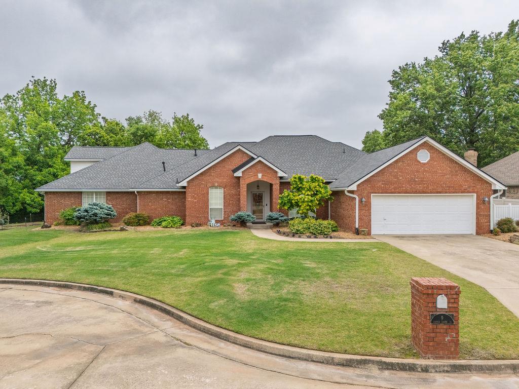 Traditional brick residence with a gabled roofline and attached garage