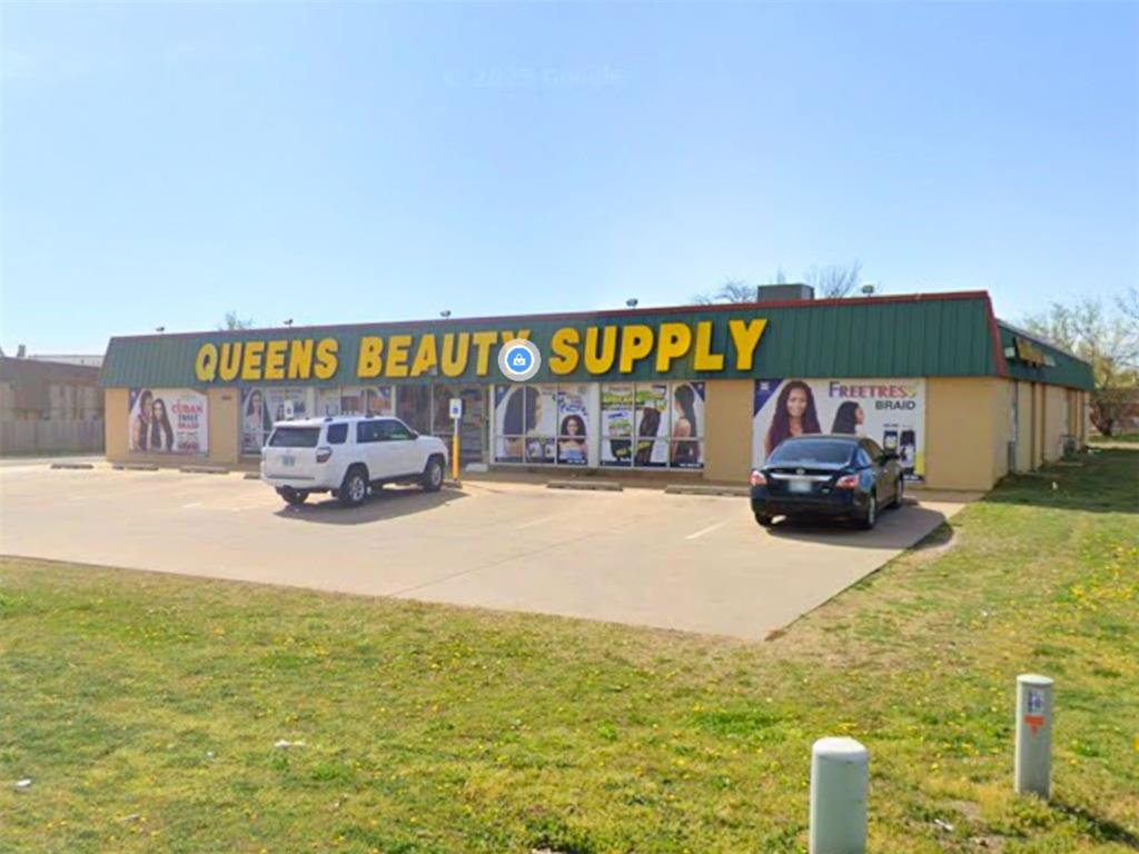 View of commercial property with uncovered parking