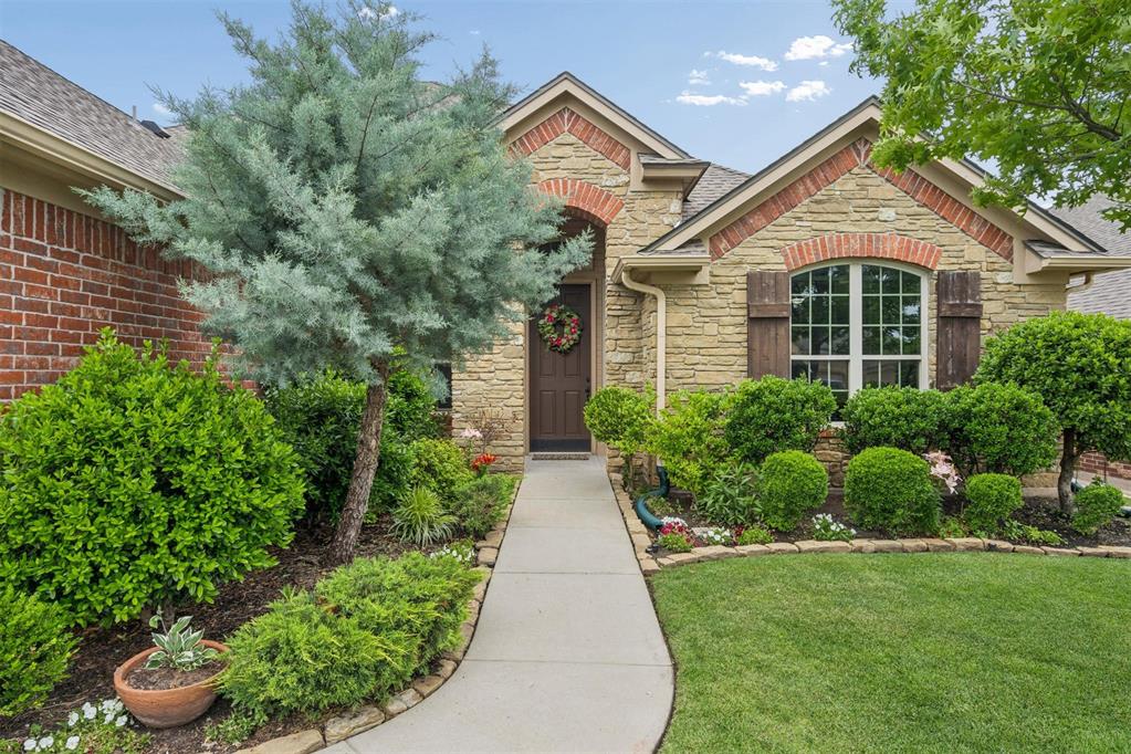 Stone and brick exterior with a prominent arched window and decorative shutters