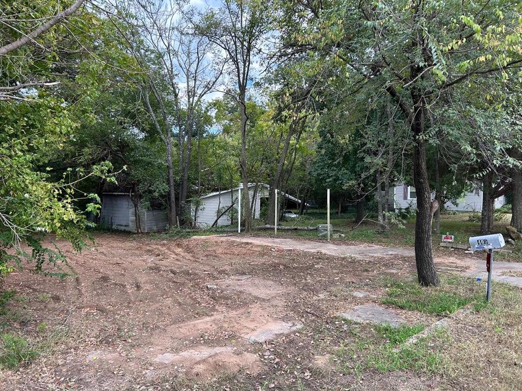 View of yard with view of wooded area