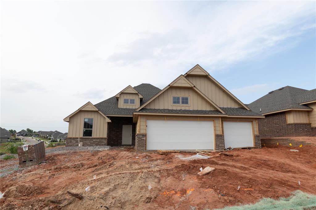 View of front of property with board and batten siding and a front lawn