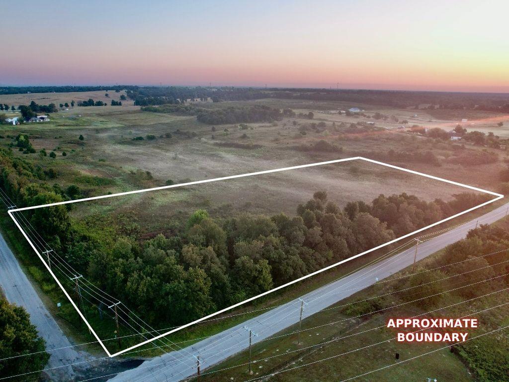 Aerial view at dusk of property parcel outlined and a rural view