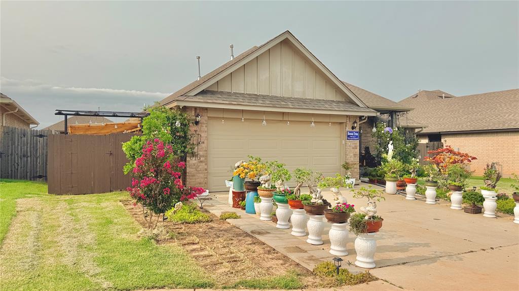 Single-story residence featuring a brick and siding exterior, an attached two-car garage, a concrete driveway, and a front entry with a small porch