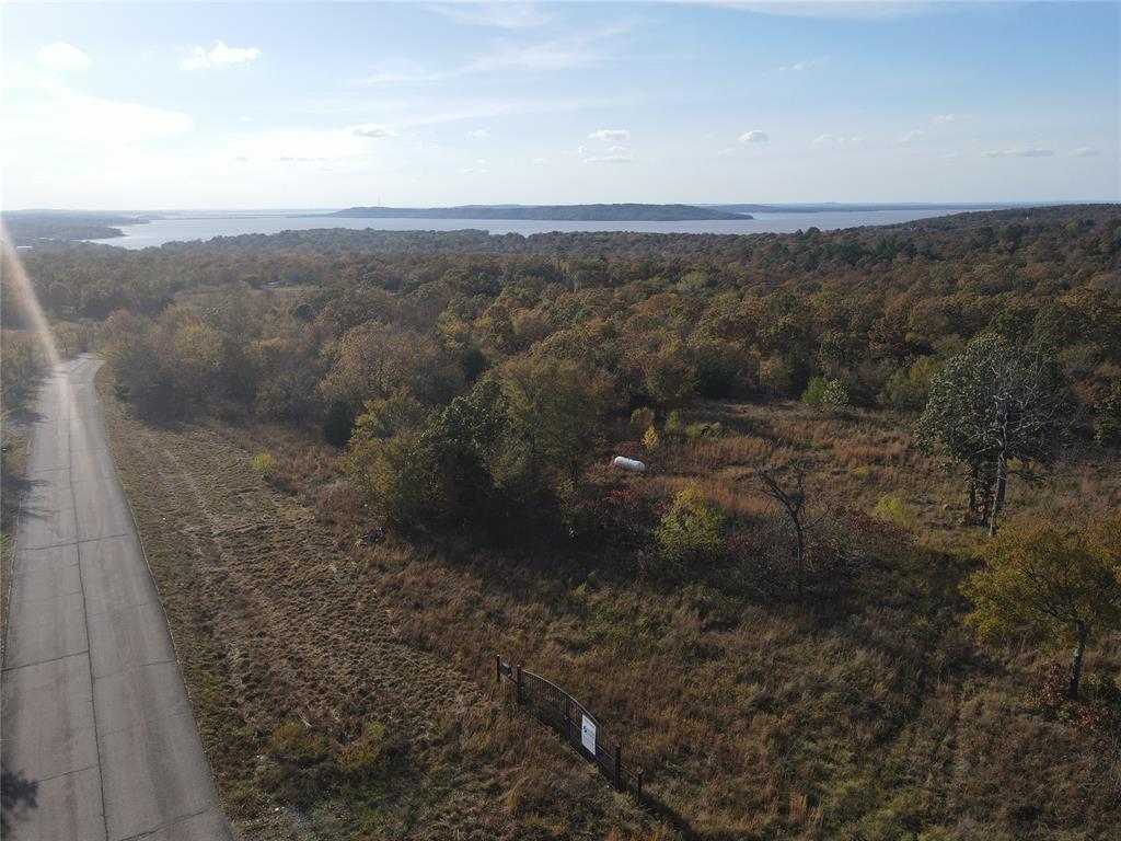 Aerial view of property and surrounding area featuring a large body of water