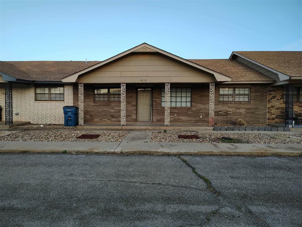 Brick exterior with a covered entryway, decorative porch columns, and a gabled roofline