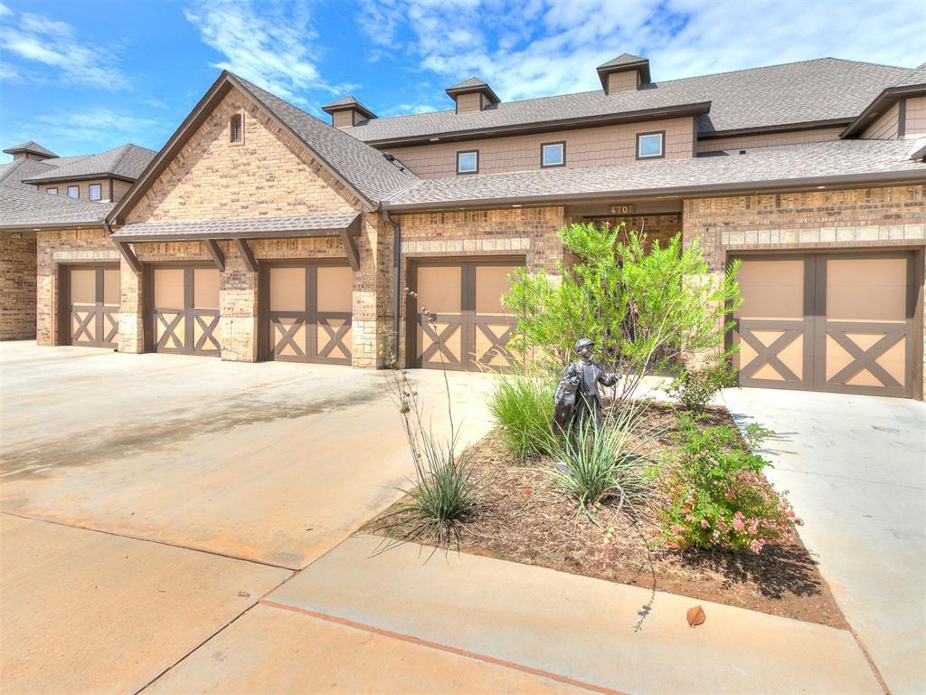 The property features a brick exterior with multiple garage doors, each adorned with a decorative X-pattern