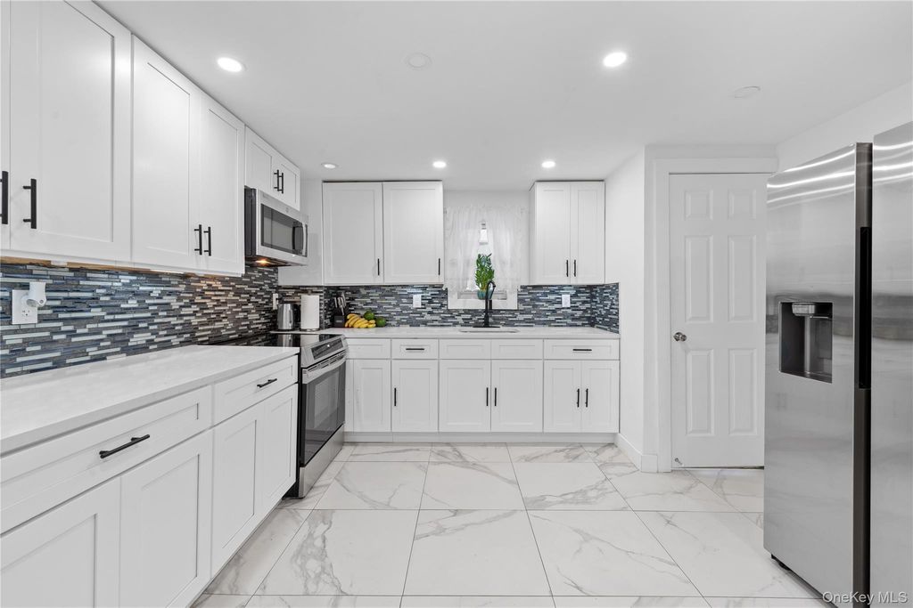 Photo of 11619 141st Street, Jamaica, NY 11436 (MLS # 942406)