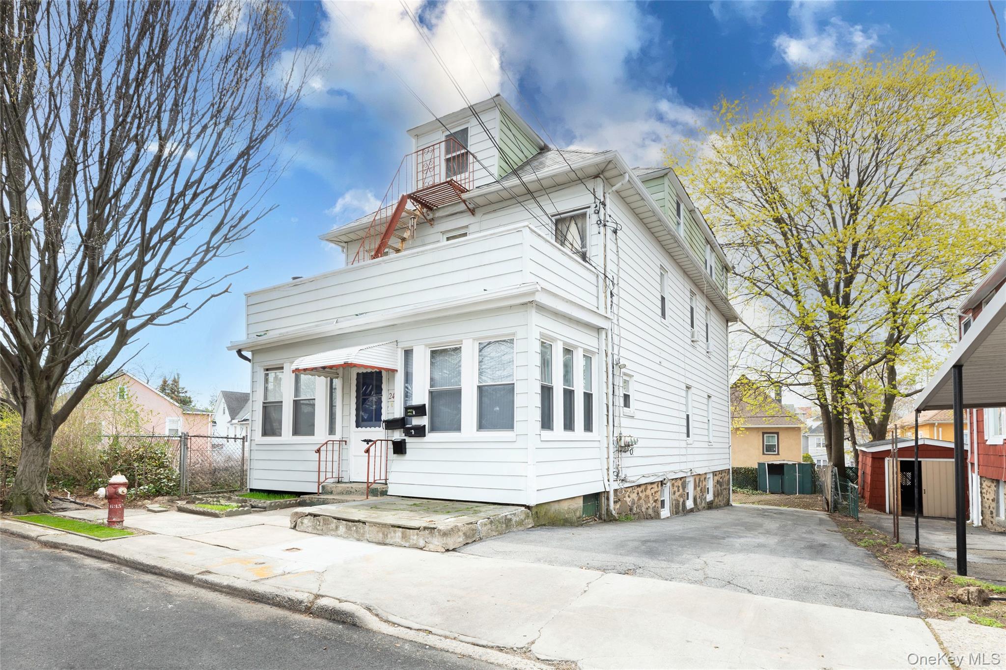 The property features a white exterior, multiple windows, and a clear entryway