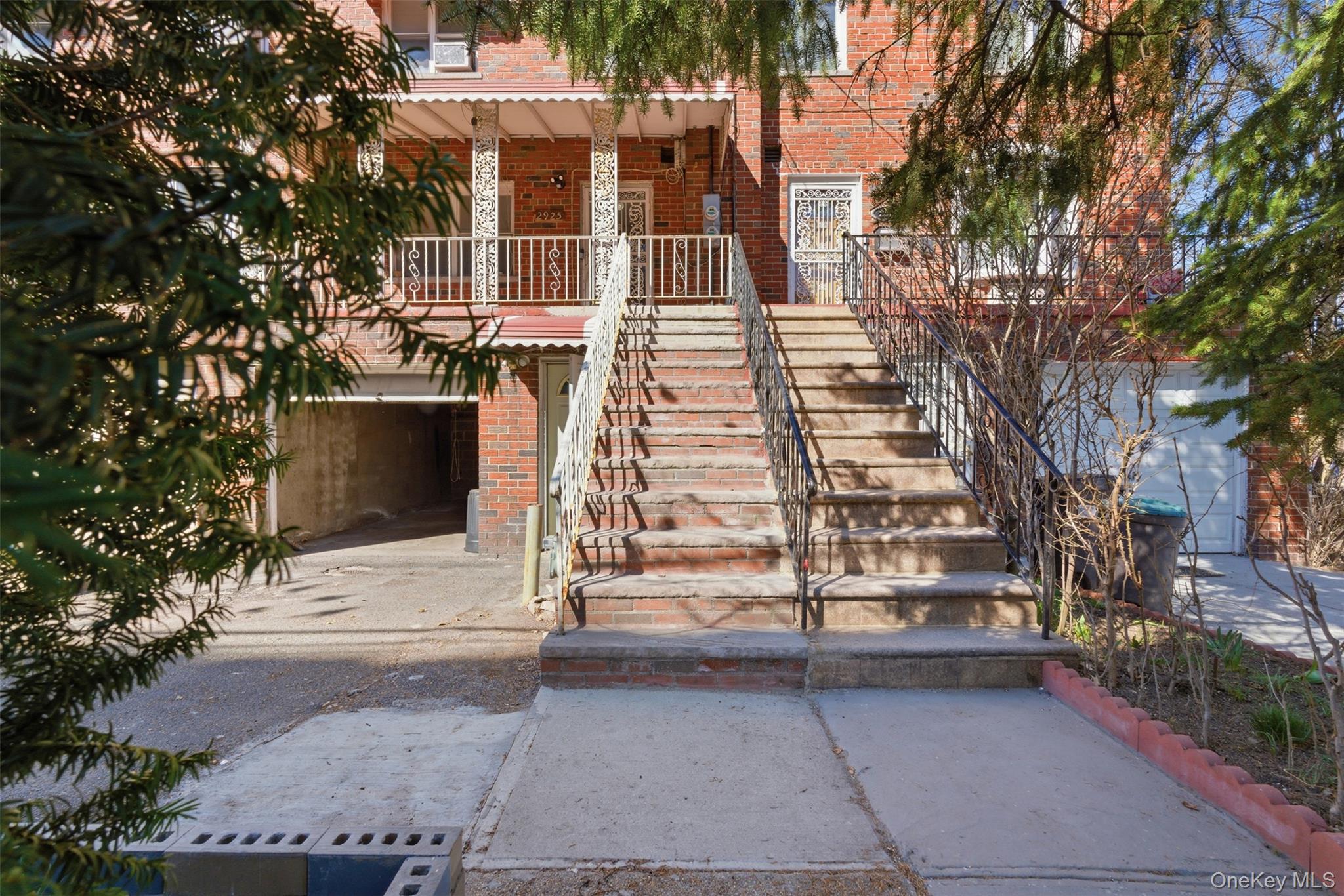 Entrance to property with brick siding and covered porch