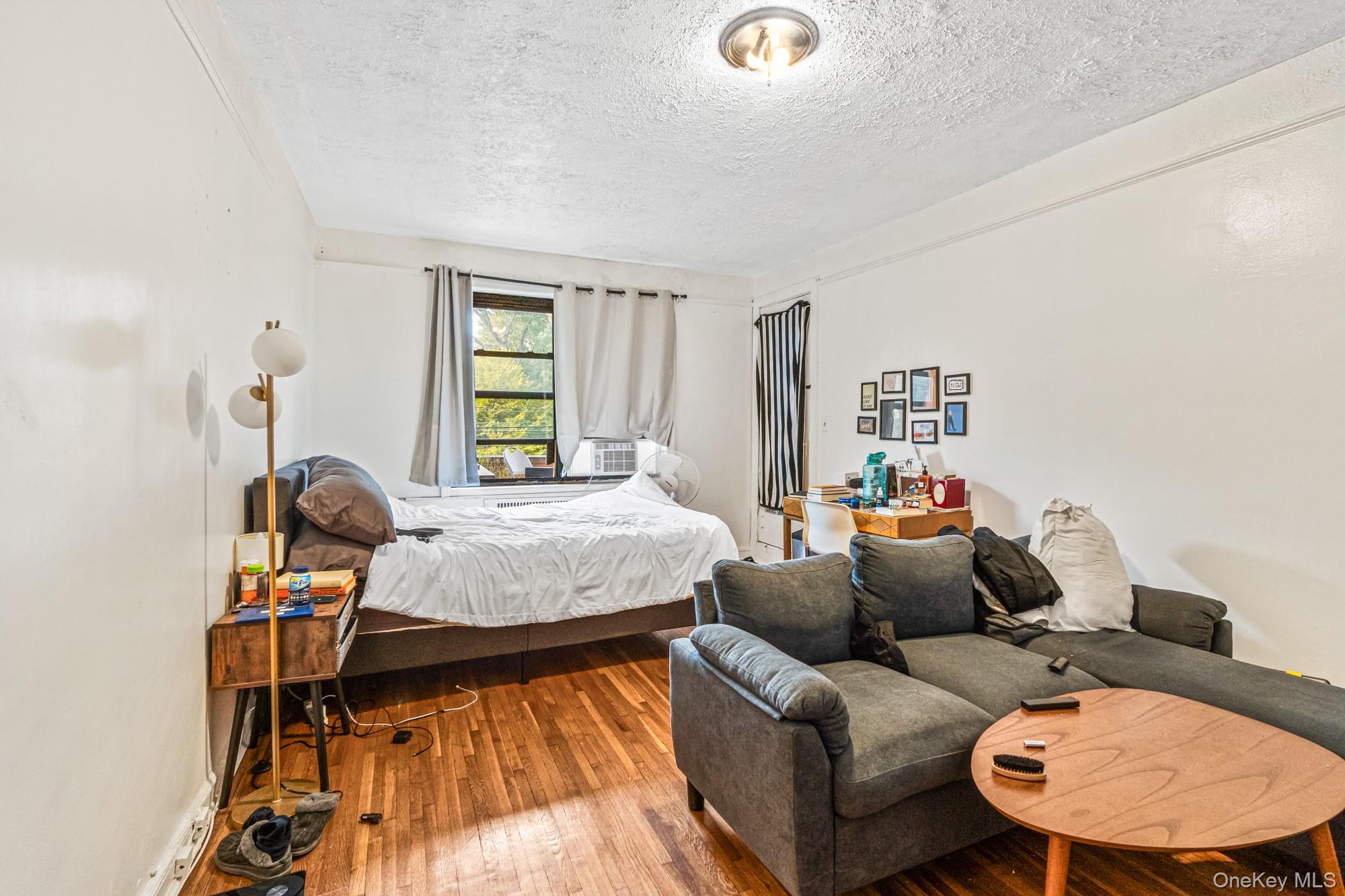 Bedroom featuring wood-type flooring and a textured ceiling