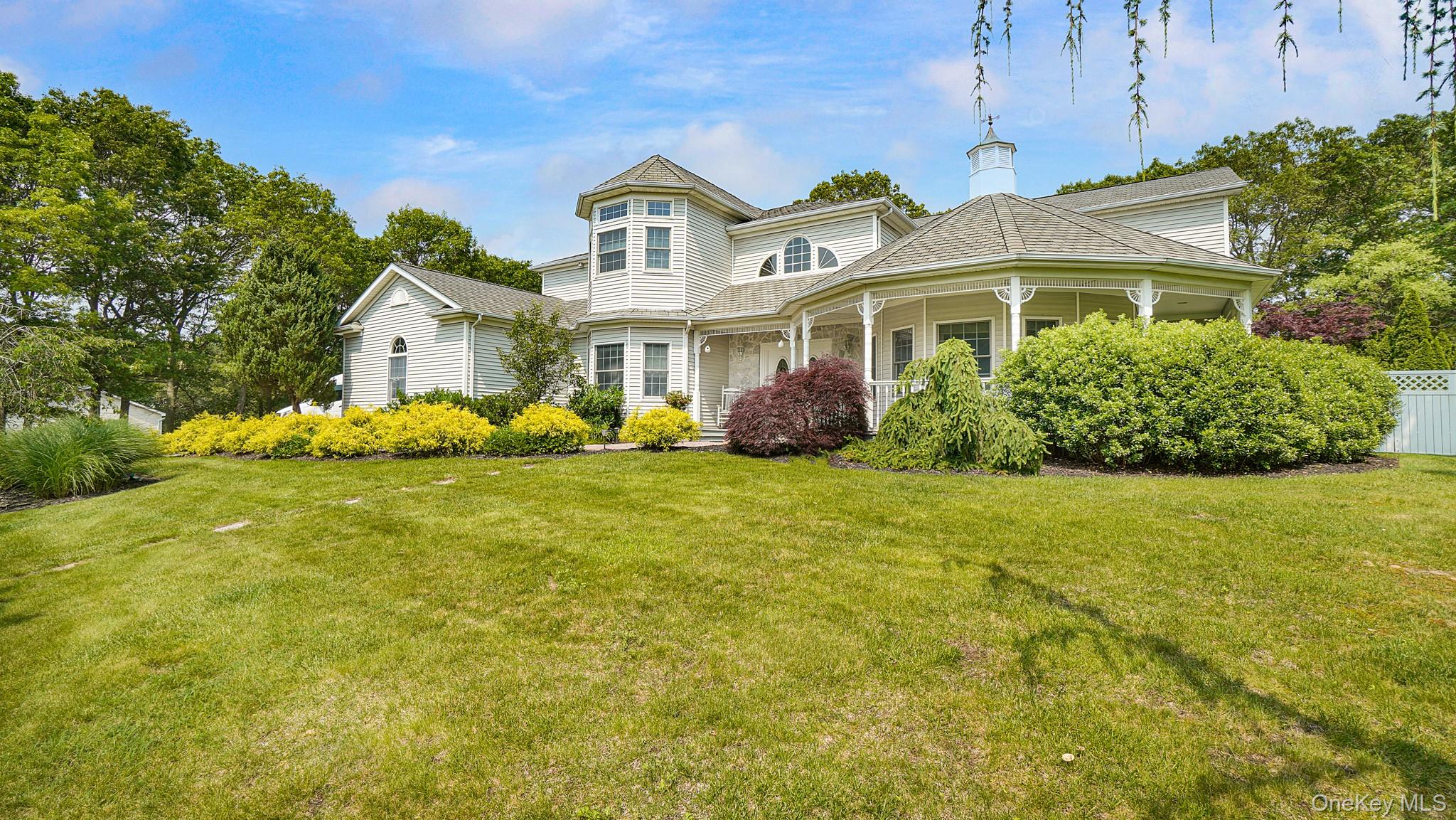 Victorian-style house featuring covered porch and a chimney