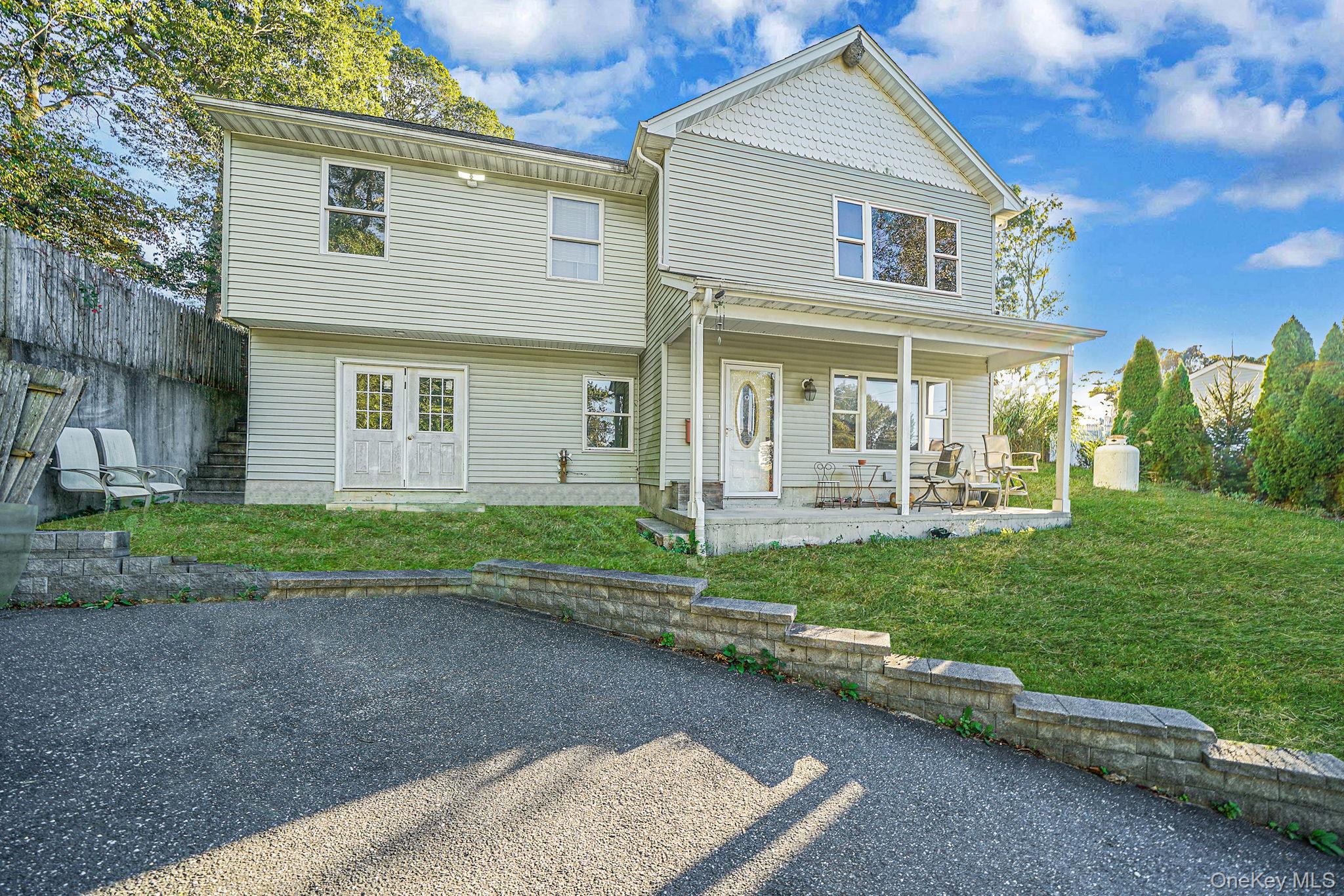 Rear view of property with a yard and a porch
