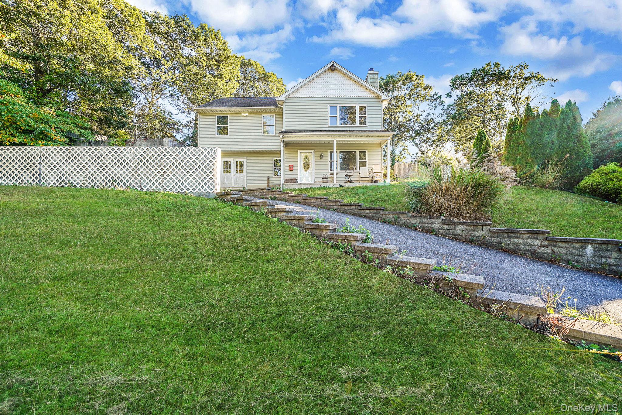View of front of house with a chimney and a porch
