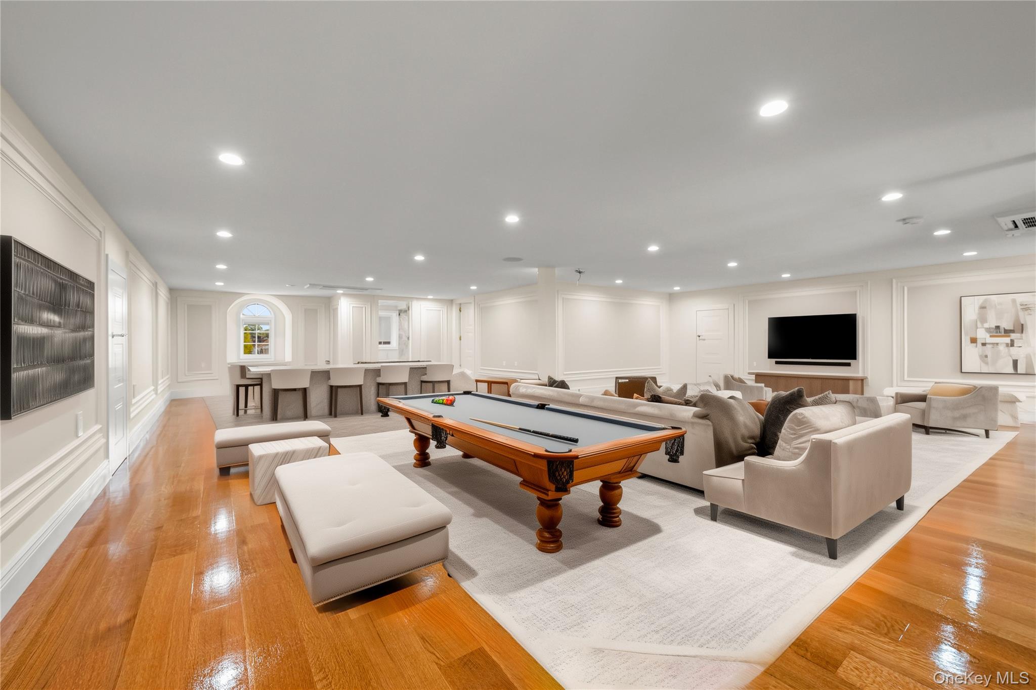 Recreation room with a decorative wall, billiards table, light wood-type flooring, and recessed lighting